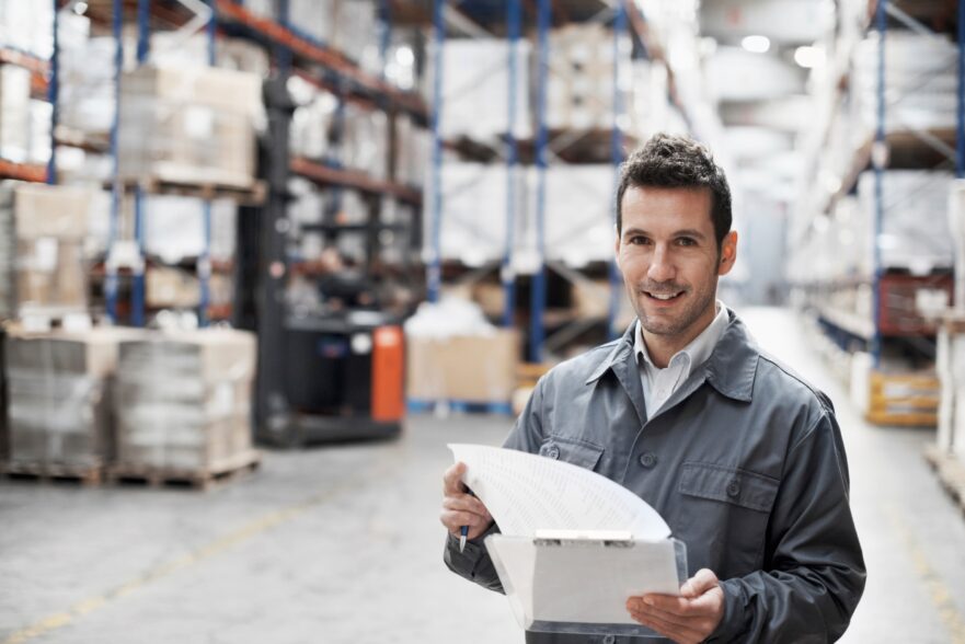 Image of a man in a warehouse that uses a placard label holder